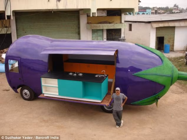 Yadav tự hào đứng bên cạnh một chiếc xe mang hình dạng quả cà tím mà ông đã chế tạo.