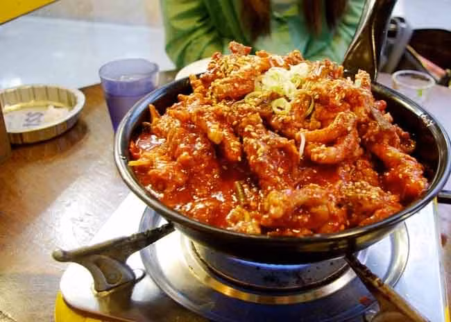 2. Chân gà là một thực phẩm phổ biến trong nhiều nước châu Á, trong đó có Hàn Quốc. Tuy nhiên, cách chế biến món chân gà của người Hàn Quốc lại rất khác biệt. Món chân gà cay - Hansin Pocha mang đậm thanh phong cách thực phẩm của Hàn Quốc bởi nó cũng có được chế biến với rất nhiều ớt khiến món ăn có màu đỏ đặc trưng.