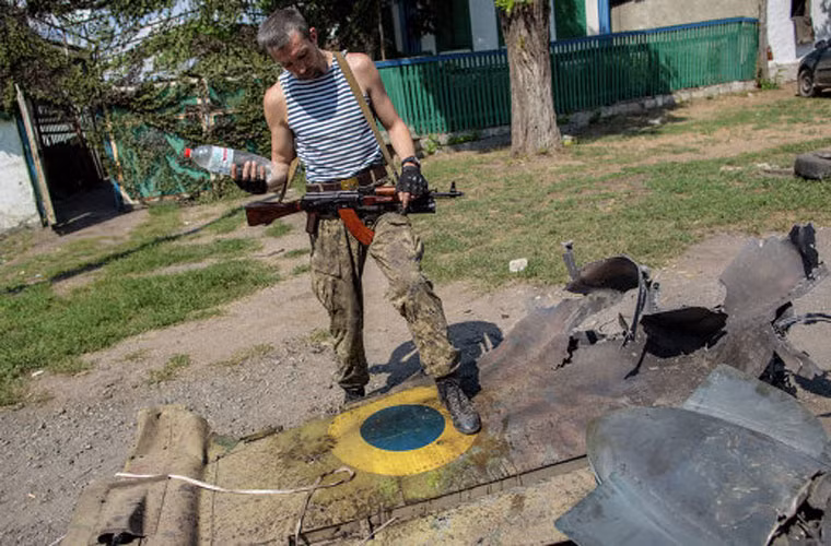 Trong ảnh là chiến binh quân ly khai đứng trên mảnh xác máy bay Su-25 Không quân Ukraine bị bắn hạ.