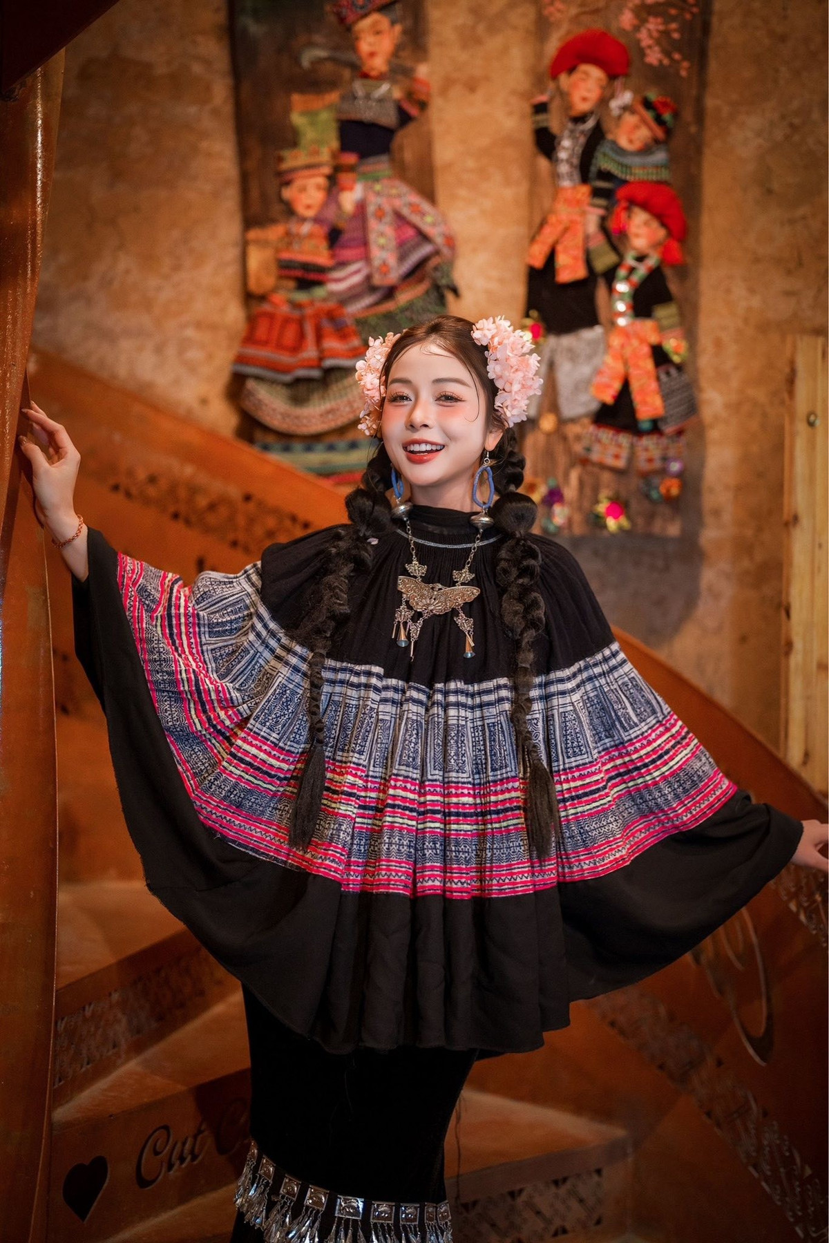 Điểm nhấn của tổng thể là kiềng bạc và đôi khuyên tai to bản ấn tượng, mang đậm hơi thở văn hóa vùng cao.