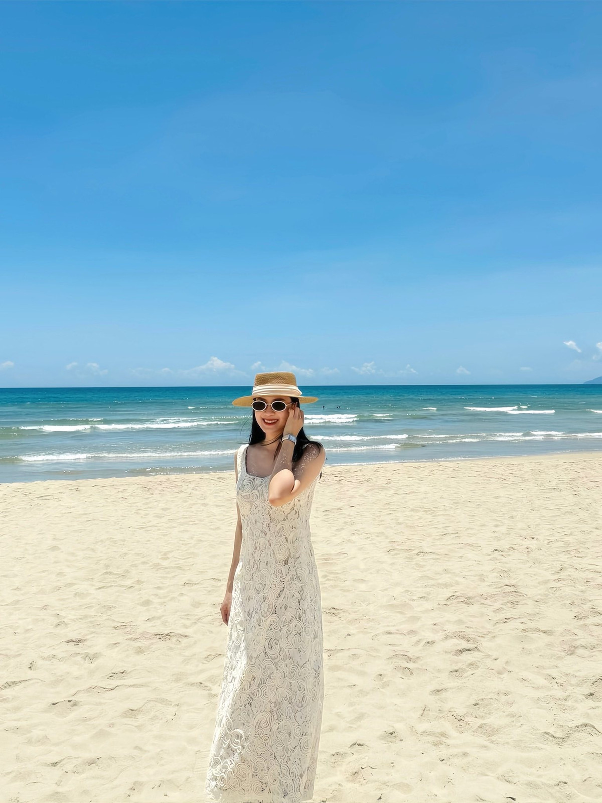 Trước đó, Hồng Diễm diện váy ren trắng dáng dài, chụp ảnh khoe dáng ở biển. Ảnh: FB Nguyen Hong Diem