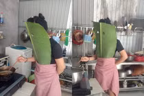 Vào bếp rán cá, người phụ nữ có màn bảo hộ kín người