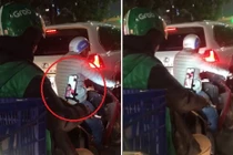 Dừng chờ đèn đỏ, tài xế Grab tranh thủ gọi điện cho vợ con