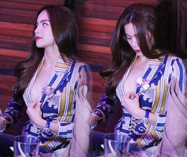 Kiểu đồ có thiết kế xẻ sâu phần ngực như thế này khiến Hồ Ngọc Hà phải kéo áo để kín đáo hơn.