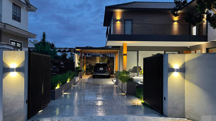 Garage được bố trí gọn gàng. Khi có nhiều khách, xe sẽ đỗ ở sân nhà ông bà bên cạnh. Cổng vào của ô tô là cổng điện. Đường vào có đèn dẫn hướng ở tầm thấp. Từ cổng vào garage, thay giầy dép để vào nhà, toàn bộ quá trình đều không bị ảnh hưởng bởi nắng mưa.