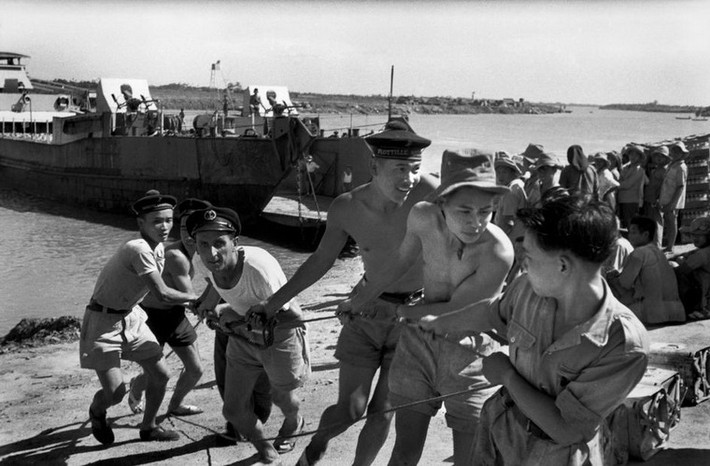 Binh lính Pháp và Việt kéo dây cáp của một chiếc xà lan, 5/1954.