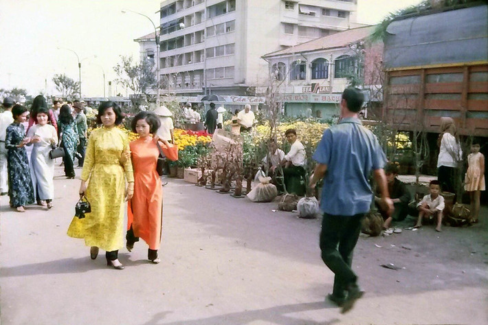 Hai thiếu như áo dài du ngoạn chợ hoa Tết Sài Gòn.