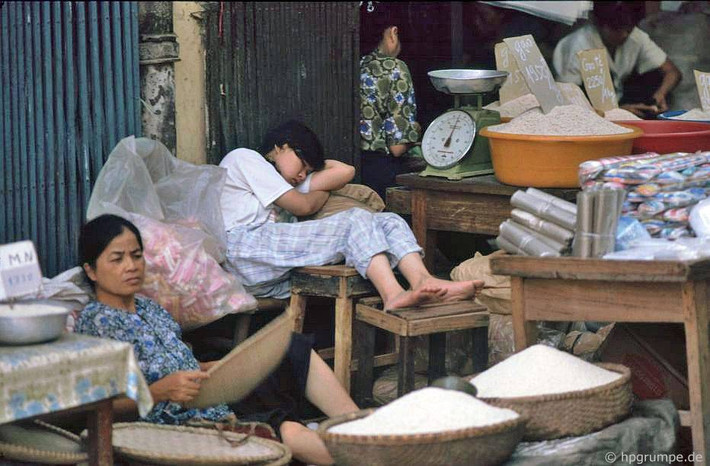 Cửa hàng gạo với các loại gạo được chất trong chậu nhựa và thúng tre.