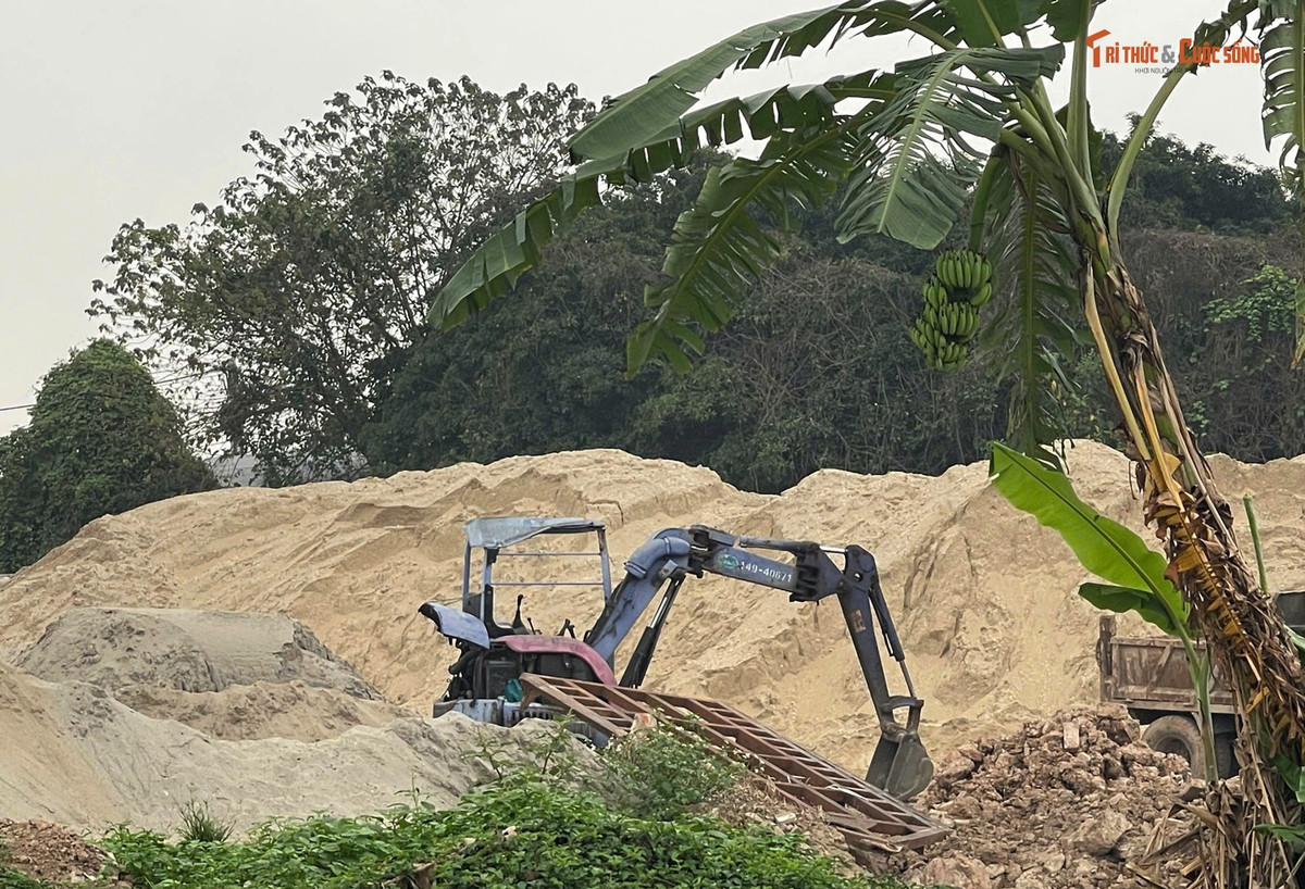 Máy xúc loại nhỏ và xe ba bánh trong bãi nhằm phục vụ cho việc vận chuyển, chở cát, sỏi, gạch từ bãi đến các công trình.