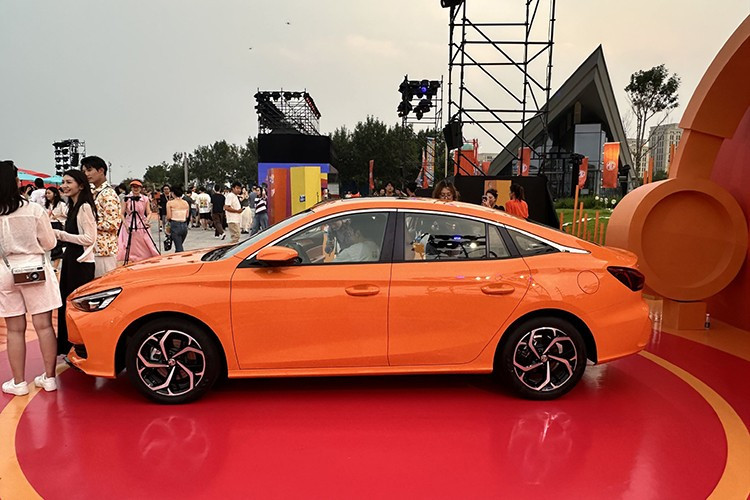 MG5 2026 vẫn giữ nguyên kiểu dáng fastback thể thao của thế hệ trước, đồng thời bổ sung hai tùy chọn màu ngoại thất mới: cam và xám, bên cạnh đỏ và trắng. Phần đầu xe nổi bật với lưới tản nhiệt dạng thác nước cỡ lớn, kết hợp cùng đèn pha mảnh và nắp ca-pô có gân nổi.