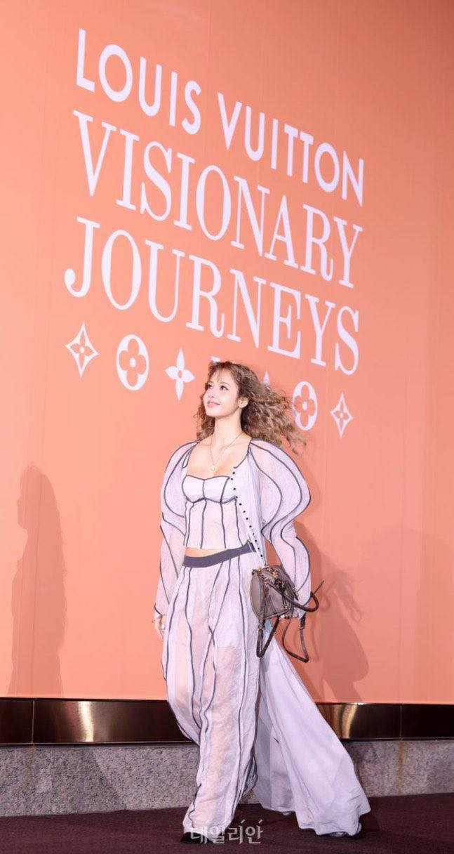 Trang phục xuyên thấu nhiều lớp, kết hợp đường cắt may lạ mắt tạo hiệu ứng thị giác mạnh. Chiếc corset trắng bên trong làm nổi bật vóc dáng mảnh mai, trong khi phần áo ngoài với chất liệu mỏng thả rơi tự nhiên tạo cảm giác mềm mại và thời thượng. Tổng thể mang hơi hướng vừa cổ điển, vừa độc đáo, rất dễ khiến người xem liên tưởng tới phong cách high-fashion thường thấy trên Lisa.