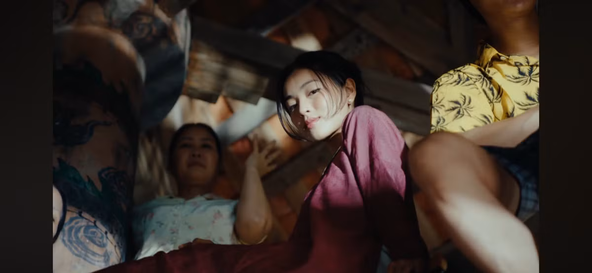 Bên cạnh đó, Lan Thy kết hợp với một chiếc vòng cổ bạc dạng kiềng tròn, mang đậm dấu ấn trang sức dân tộc, và đôi khuyên tai nhỏ, tinh tế. Mái tóc đen được búi gọn gàng, tôn lên khuôn mặt thanh thoát.