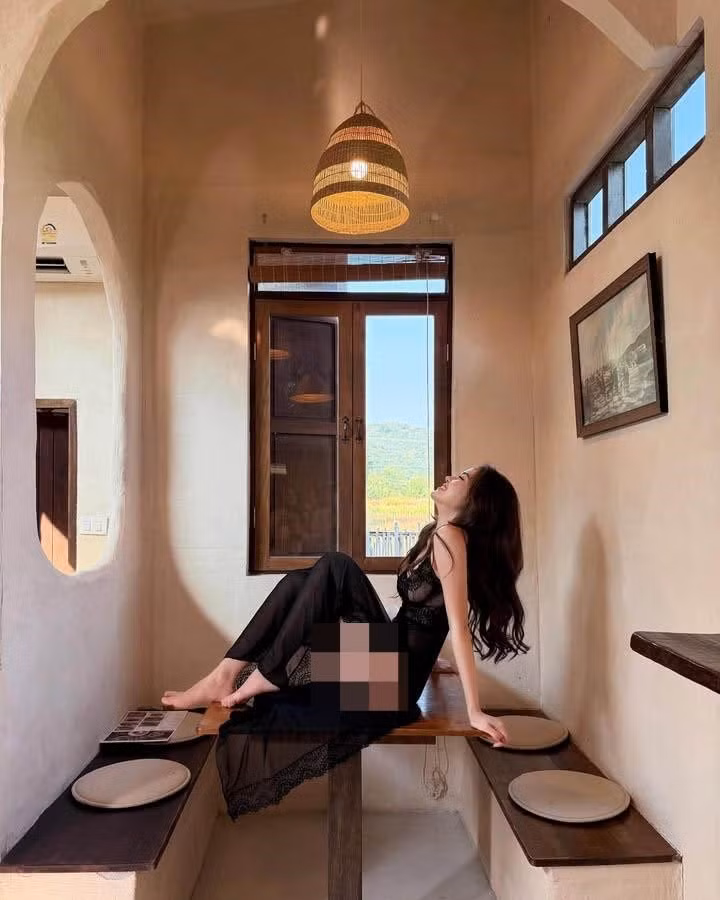 Làn da trắng sứ mịn màng như phát sáng của nàng hot girl Thái Lan dưới ánh nắng hoàng hôn len lỏi qua khe cửa, làm tôn lên bờ vai trần thon thả và tấm lưng trần nuột nà.