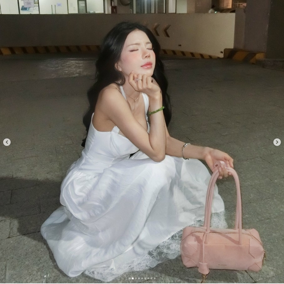 Outfit trắng ôm dáng giúp Mai Dora khoe trọn lợi thế hình thể nhưng vẫn giữ được sự thanh lịch. Những chi tiết như dây buộc vai, vòng cổ mảnh và vòng tay ngọc tạo điểm nhấn nhẹ nhàng, giúp tổng thể càng thêm sang và hài hoà.