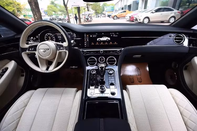 Bên trong khoang lái của chiếc Coupe siêu sang Bentley Continental GT V8 có màu trắng-đen. Nội thất xe còn được trang bị màn hình trung tâm cảm ứng kích thước lớn được ẩn giấu một cách tinh tế bên trong bảng táp-lô ốp gỗ và bên dưới là một chiếc đồng hồ cơ đặt ngay vị trí trung tâm, cần số điện tử cỡ lớn.