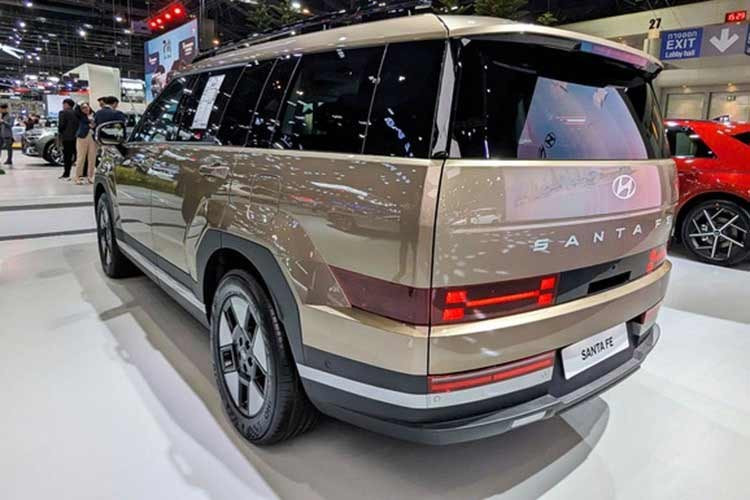 Ngoại hình SantaFe Hybrid 2026 tương tự bản động cơ đốt trong với tạo hình vuông vức, bề thế. Ngay từ phiên bản Exclusive tiêu chuẩn, xe đã sở hữu danh sách trang bị khá đầy đủ với đèn LED chạy ban ngày, đèn hậu LED, đèn chào mừng, kính chắn gió hai lớp và mâm 18 inch đi kèm cốp điện rảnh tay.