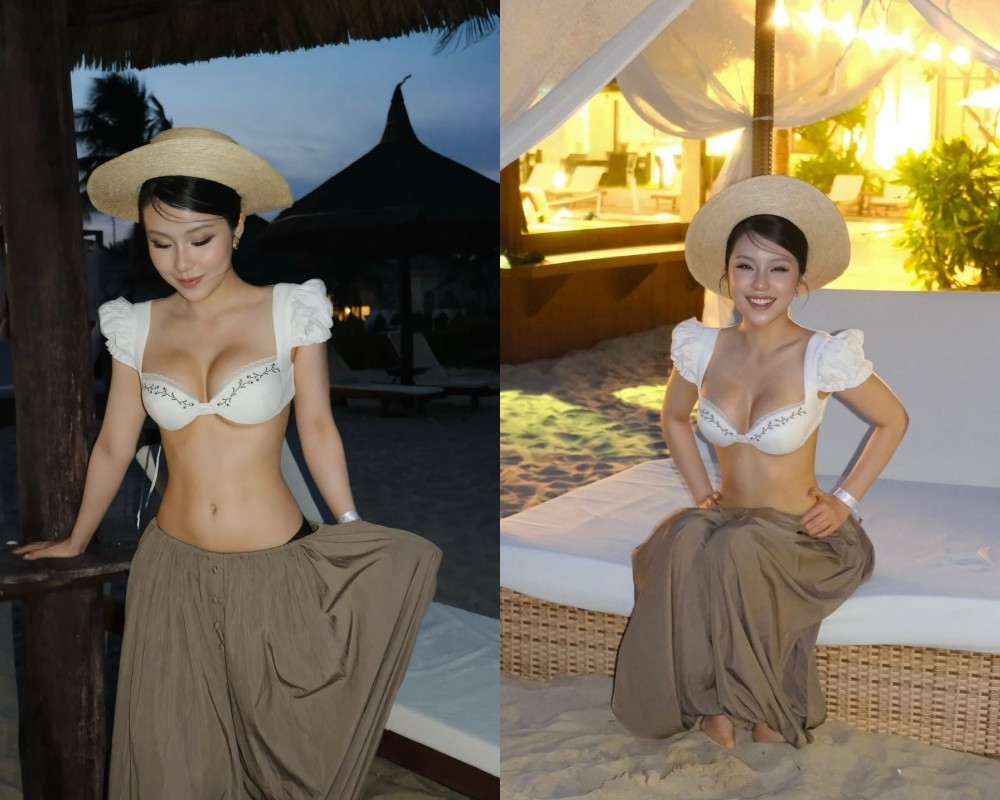 Nữ TikToker diện một thiết kế áo bra-top màu trắng, mô phỏng kiểu dáng áo "dirndl" (trang phục truyền thống của Đức) với chi tiết tay bồng đầy nữ tính và đường thêu hoa tinh tế. Thiết kế này khéo léo tôn lên vòng một đầy đặn, gợi cảm của nữ TikToker.