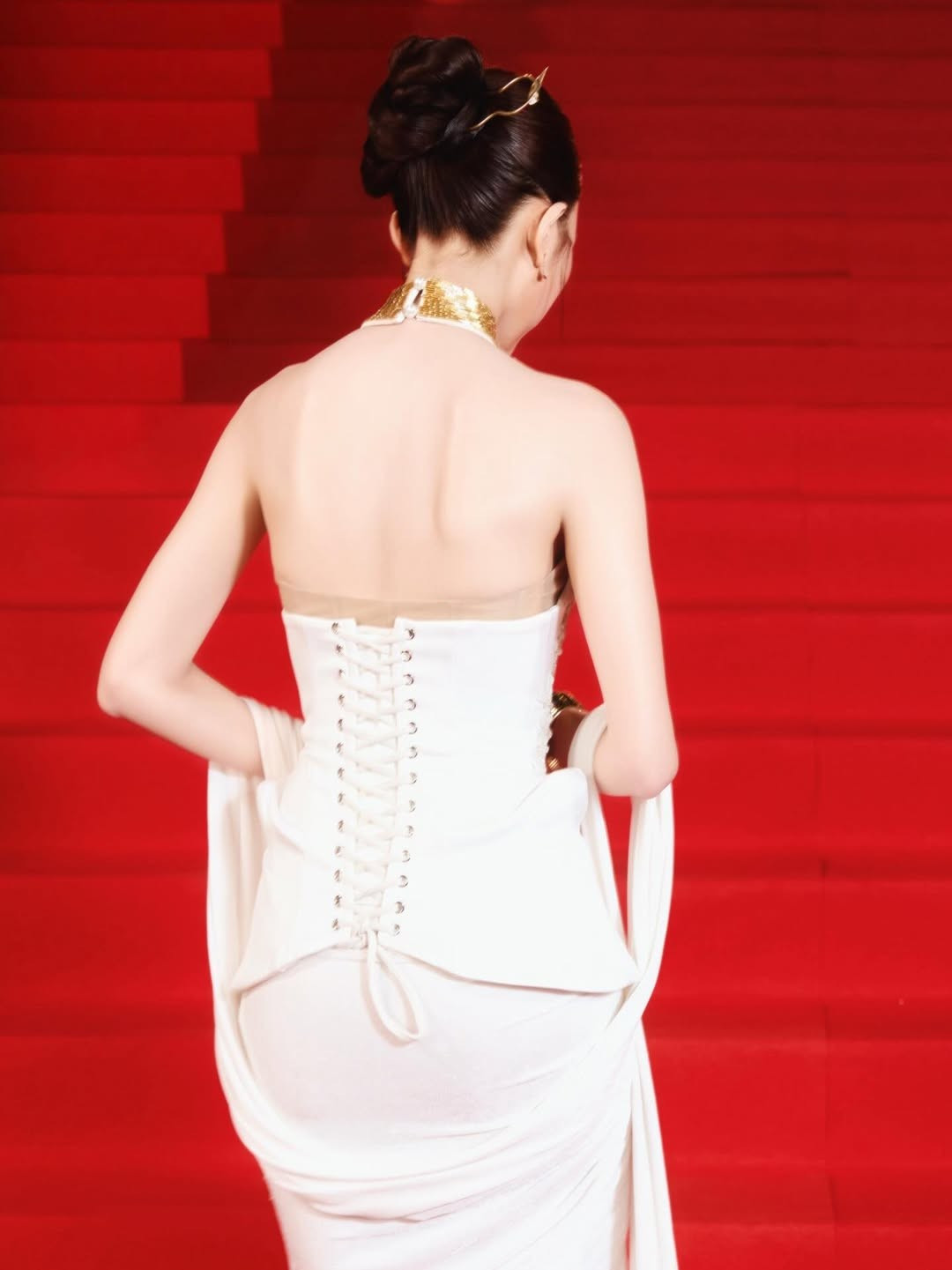 Bộ trang phục mang phom dáng cổ điển nhưng được xử lý chất liệu mềm rủ hiện đại, giúp tôn lên vóc dáng thanh mảnh và thần thái kiêu sa của nữ nghệ sĩ sinh năm 2003.