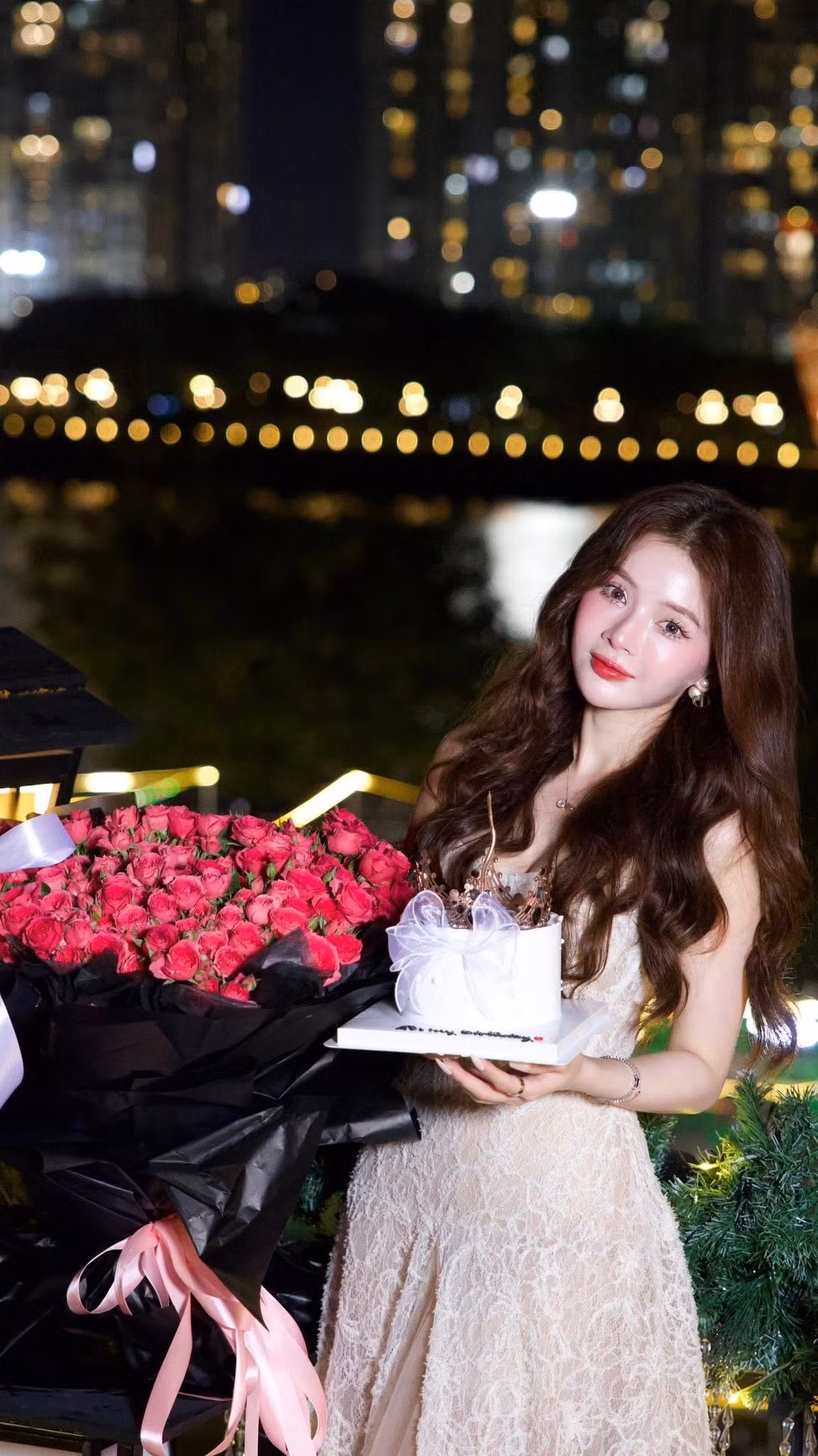 Khung cảnh tiệc sinh nhật của Lan Hương vô cùng lãng mạn và xa hoa. Cô nàng chọn tổ chức ở một không gian sang trọng, có view nhìn ra thành phố lung linh ánh đèn vào buổi tối. Đặc biệt, trong một bức ảnh, có thể thấy rõ tòa nhà Landmark 81 nổi tiếng của Sài Gòn rực rỡ phía sau, tạo nên phông nền "triệu đô" cho buổi tiệc.