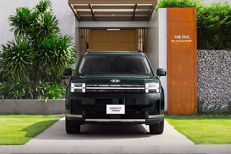 Hyundai SantaFe Hybrid 2026 sở hữu chiều dài cơ sở 2.815 mm mang đến không gian nội thất rộng rãi và thoải mái. Phần đầu xe nổi bật với cụm đèn chiếu sáng thích ứng (HBA-LED) và dải đèn ban ngày tạo hình chữ H đặc trưng của Hyundai.