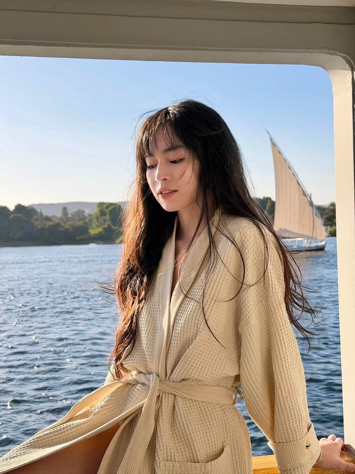 Không cần tạo dáng cầu kỳ, chỉ với những khoảnh khắc ngồi tựa lan can, khẽ ngẩng mặt đón nắng hay đưa tay cảm nhận làn gió sông Nile, Đỗ Khánh Vân đã mang đến loạt hình ảnh đầy chất điện ảnh.