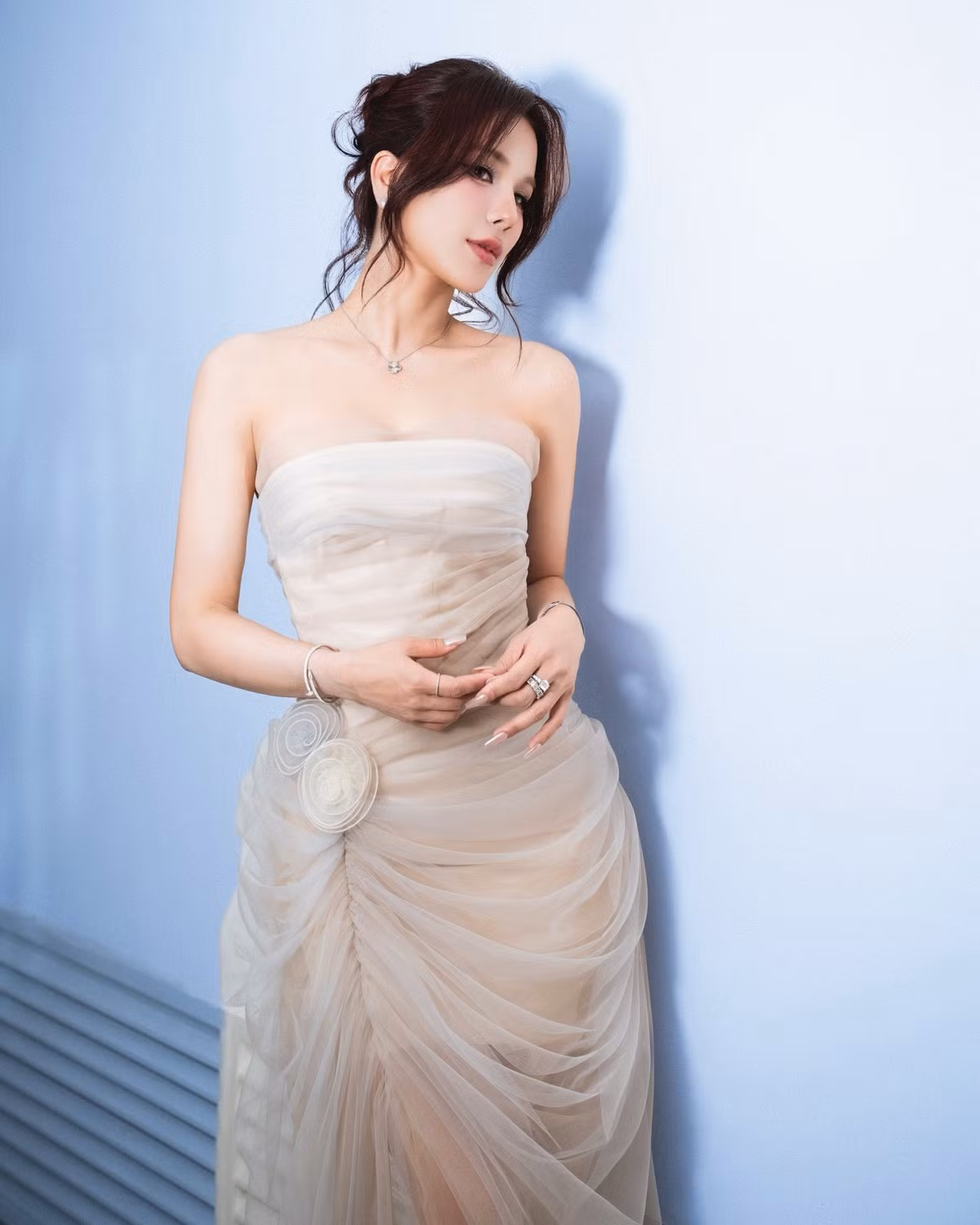 Mái tóc búi hờ, thả vài lọn xoăn mềm càng tôn lên vẻ dịu dàng, khác biệt với hình ảnh cá tính, mạnh mẽ vốn quen thuộc của cô suốt nhiều năm qua.