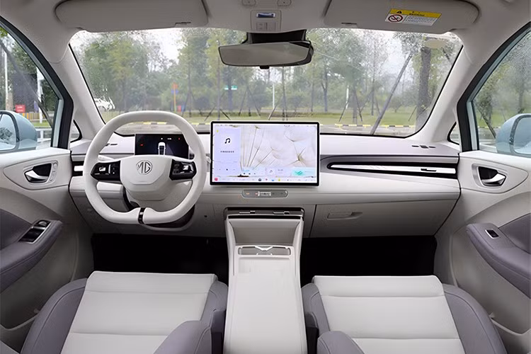 Đuôi xe có dải đèn LED kéo ngang toàn chiều rộng, đèn định vị hình mũi tên. Nhìn chung, MG4 Anxin Edition hướng đến sự quen thuộc nhưng hiện đại thông qua những tinh chỉnh nhẹ. Không gian bên trong được cập nhật theo hướng tối giản và công nghệ hơn. Màn hình trung tâm tăng kích thước từ 12.3 lên 15.6 inch.