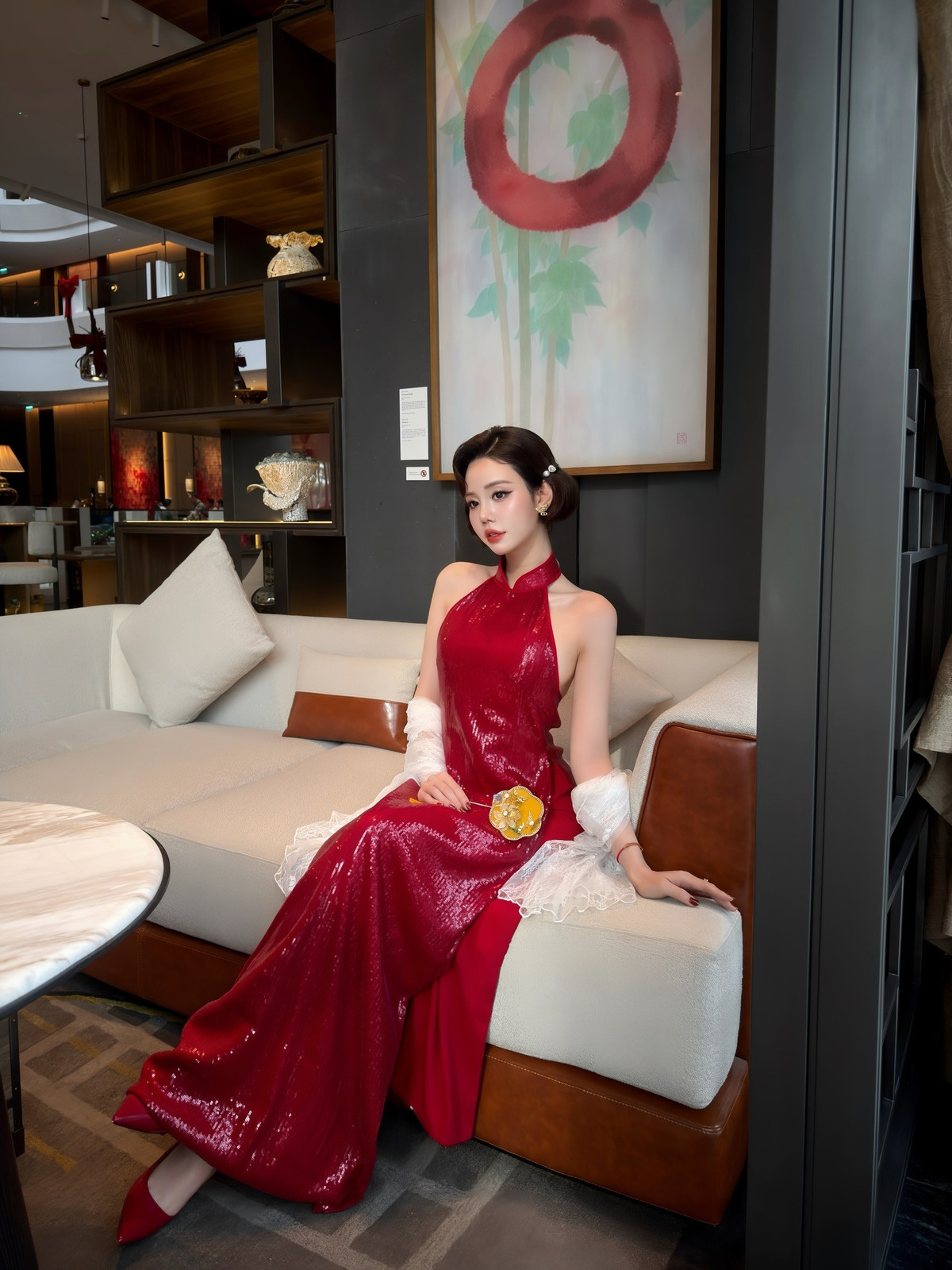 Kiểu tóc uốn gợn nhẹ, tạo hình cổ điển kết hợp cùng lối trang điểm tinh tế càng làm nổi bật đôi mắt to tròn, sống mũi cao và thần thái đài các. Áo dài cách tân với phần cổ yếm, lưng trần khéo léo khoe bờ vai mảnh mai, mang đến cảm giác vừa kín đáo vừa gợi cảm.