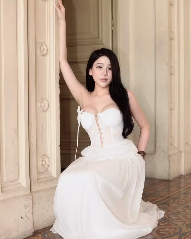 "Phú bà" làng streamer xuất hiện trong một chiếc đầm dạ hội trắng dài, khéo léo khoe trọn vòng 1 căng tràn cùng bờ vai trần gợi cảm, tạo nên một hình ảnh hoàn toàn khác lạ so với sự cá tính thường thấy.