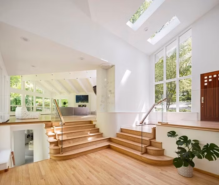 Khu vực cầu thang trung tâm ngập tràn ánh sáng nhờ giếng trời và hệ cửa kính lớn. Ảnh: Homedit