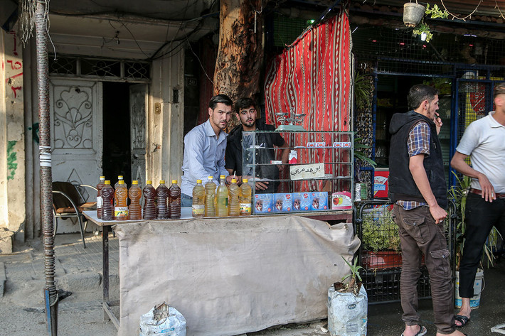Một người đàn ông bán thuốc lá và các chai xăng. Lực lượng chính phủ Syria chỉ hiện diện ở ngoại ô khu vực này. Họ kiểm soát các thị trấn, con đường, căn cứ quân sự và trạm kiểm soát quanh đây.
