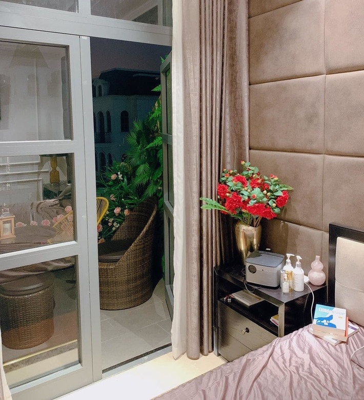 Thu Hương chứng minh sự khéo léo khi trang trí một góc phòng bằng đóa hoa rực rỡ, bên cạnh đó là lối ra ban công.