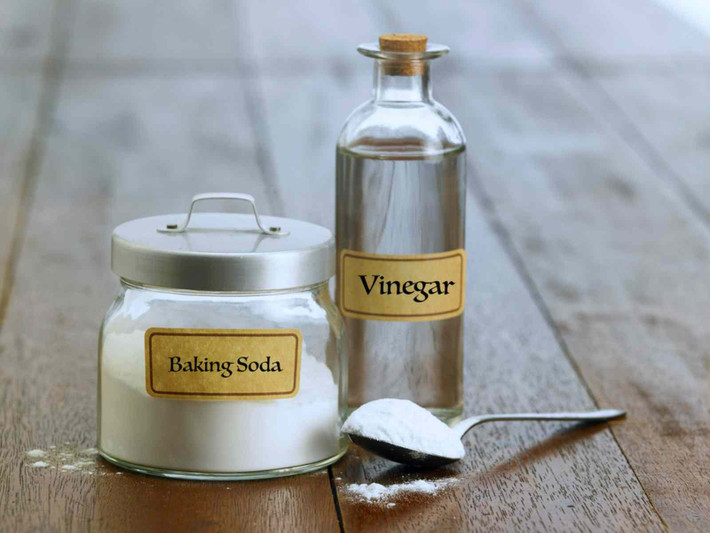 Dùng baking soda, chanh và giấm trắng: Nếu không muốn dùng nước tẩy rửa hóa học cũng không có thời gian cho việc tự ngâm một hỗn hợp nước tẩy rửa hữu cơ, hãy trộn ngay 2 thìa baking soda với 2 thìa nước cốt chanh vào nửa chén giấm trắng, tạo thành hỗn hợp sền sệt và dùng khăn vải lau bếp bôi đều hỗn hợp này lên bề mặt bếp gas, ống hút khói, để khoảng 10-15 phút với các vết bẩn cứng đầu và sau đó thấm nước ấm vào khăn, lau lại bề mặt đó là bạn đã hoàn toàn loại bỏ khói bụi, dầu mỡ tích tụ lâu ngày. Ảnh minh họa