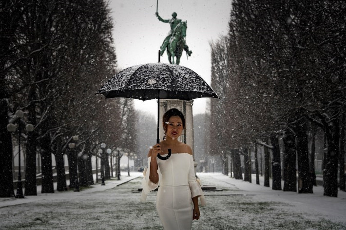 Cô dâu tạo dáng dưới tuyết trong buổi chụp hình ở thủ đô Paris. Ít nhất một con đường lớn ở phía tây nam thủ đô của Pháp đã bị đóng cửa trong vài giờ sau khi những cơn mưa mang theo tuyết dày vài cm.