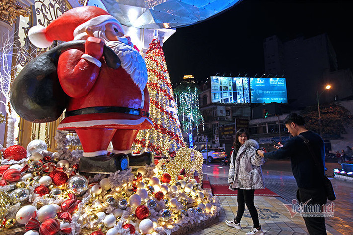 Mô hình cây thông và ông già Noel với hệ thống ánh sáng đa sắc trước cửa một trung tâm thương mại trên đường Nguyễn Thái Học.
