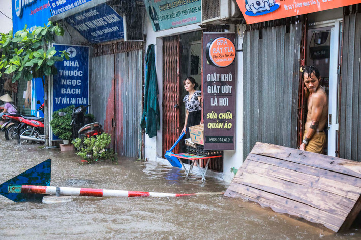 Nhiều nhà dân dùng các tấm gỗ lớn để chắn sóng do các phương tiện tạo ra tràn vào trong nhà.
