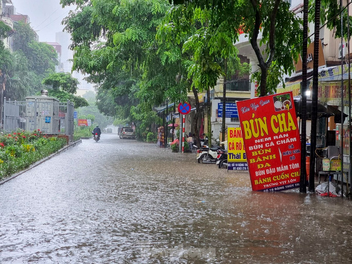 Cơn mưa lớn kéo dài trong sáng 20/8 khiến đường Đặng Thùy Trâm (quận Cầu Giấy) ngập khoảng 25cm.