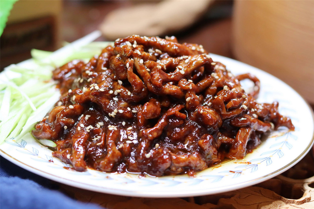 Cùng nhóm món mặn dễ ăn còn có thịt heo xào sốt tương ngọt – món ăn quen thuộc trong bữa cơm thường nhật của người Bắc Kinh, với thịt thái sợi mảnh, xào cùng tương đậu ngọt đặc trưng, hương vị hài hòa và dễ thưởng thức. Ảnh Internet