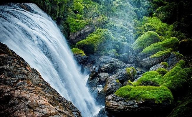 Đứng sau lớp rèm nước, du khách có thể ngắm toàn cảnh thác từ bên trong, trải nghiệm góc nhìn hiếm có và cảm nhận rõ sức sống dữ dội nhưng vẫn đầy nghệ thuật của thiên nhiên Tây Nguyên. Ảnh VnTrip