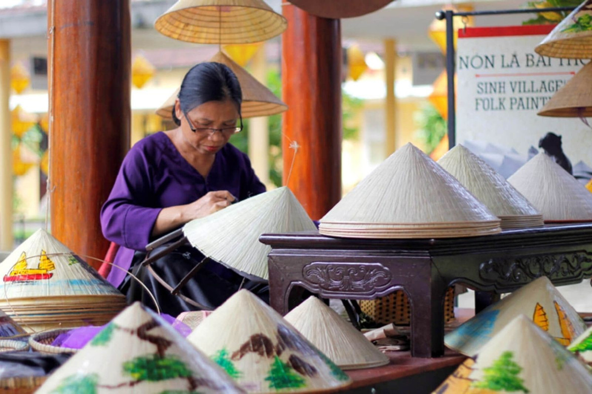 Nhắc đến Huế là nhắc đến chiếc nón bài thơ – biểu tượng của nét duyên thầm và sự tinh tế. Làng Tây Hồ chính là cái nôi gìn giữ kỹ nghệ làm nón độc đáo này. Điểm đặc biệt của nón bài thơ nằm ở những câu thơ, hình ảnh danh thắng xứ Huế được khéo léo lồng ghép giữa hai lớp lá, chỉ hiện lên khi soi dưới ánh sáng. Ảnh Sovabatravel