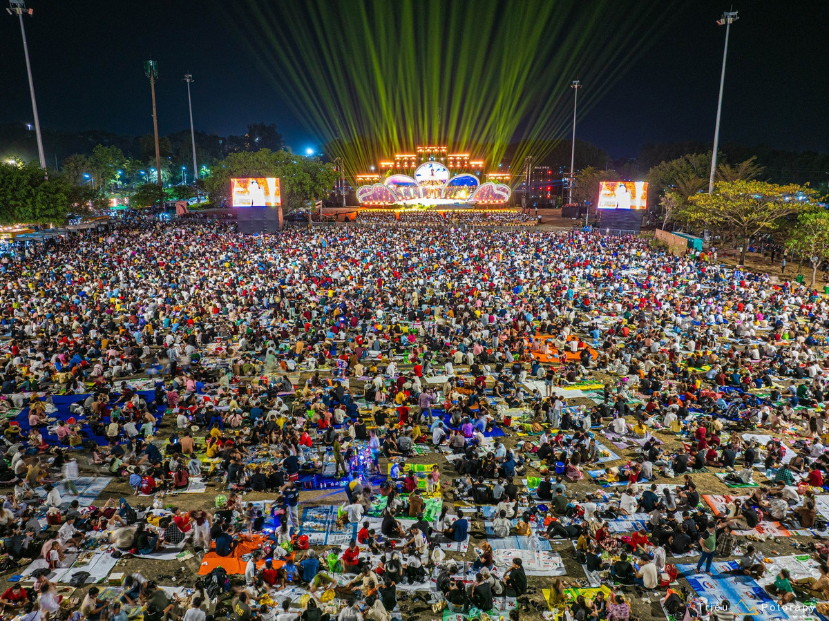 Ngay từ chiều, nhiều gia đình đã mang theo bạt, chiếu, thức ăn và nước uống để “giữ chỗ” từ sớm. Những khoảng đất trống nhanh chóng biến thành các điểm picnic ngoài trời, nơi mọi người quây quần ăn uống, trò chuyện và chờ đợi chương trình nghệ thuật buổi tối.