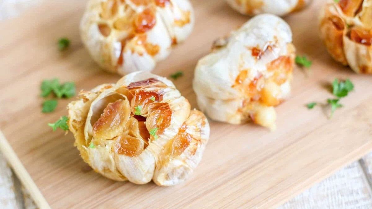 Nếu muốn thưởng thức tỏi theo cách ngon miệng hơn, tỏi nướng là gợi ý đáng thử. Khi được nướng chín, tỏi giảm độ hăng, trở nên ngọt nhẹ mà vẫn giữ lại nhiều dưỡng chất. Ảnh minh họa