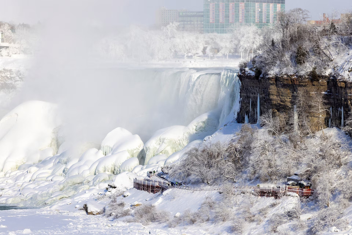 Niagara là hệ thống thác nước lớn nhất khu vực Bắc Mỹ, nằm trên biên giới Mỹ – Canada, với lưu lượng trung bình lên tới 3.160 tấn nước mỗi giây. Trong điều kiện thời tiết cực lạnh, một phần nước đổ qua thác bị đông cứng, trong khi nhiều đoạn khác vẫn chảy xiết, tạo ra những đám sương mù bốc lên rồi nhanh chóng kết tinh thành băng. Sự tương phản giữa dòng nước cuồn cuộn và lớp băng trắng xóa mang lại vẻ đẹp ảo diệu hiếm thấy.