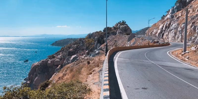 Được mệnh danh là một trong những cung đường ven biển đẹp nhất Việt Nam, tuyến Bình Hưng – Vĩnh Hy đưa du khách qua những khung cảnh đổi sắc liên tục: đồng muối Nhơn Hải lấp lánh, ruộng hành xanh mướt, hoa hoàng yến vàng rực. Từ trên cao nhìn xuống, toàn cảnh vịnh Vĩnh Hy hiện lên với tàu thuyền neo đậu bình yên giữa làn nước xanh biếc. Ảnh vietrektravel