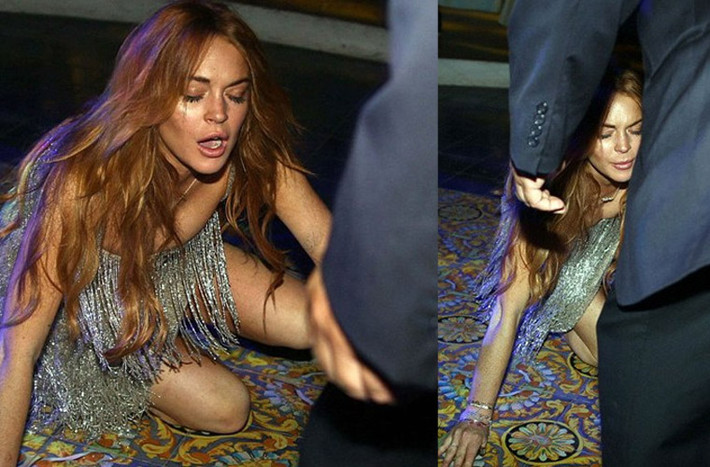 Vì bất cẩn, Lindsay Lohan bị ngã chỏng chơ ngay trên thảm đỏ LHP ở Italy và làm mồi cho cánh săn ảnh.