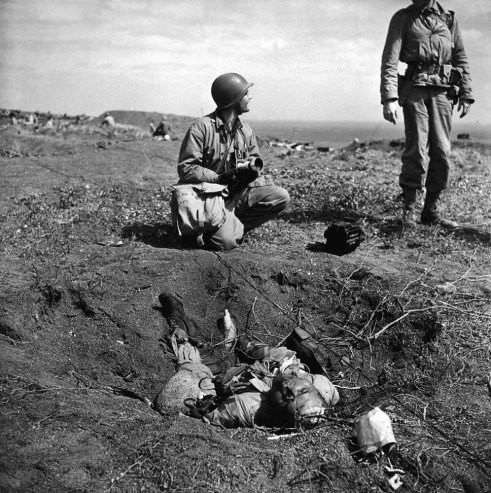 Binh sĩ Mỹ đứng gần thi thể binh sĩ Nhật Bản tử trận trên chiến trường Iwo Jima năm 1945.