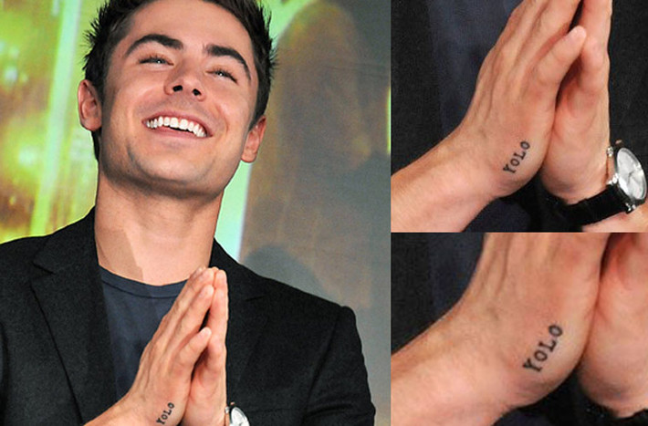 Zac Efron khiến fan Nhật ngạc nhiên khi tới đất nước mặt trời mọc hồi tháng 12.2011 khi để lộ hình xăm chữ “YOLO”, viết tắt của “you only live once” (bạn chỉ sống duy nhất một lần) trên bàn tay phải.