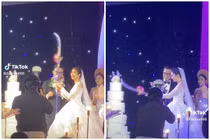 Độc lạ cặp đôi vác “kiếm khổng lồ” cắt bánh cưới như phim 