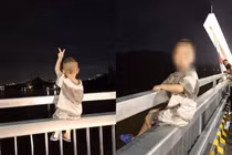 Phẫn nộ cảnh bố mẹ để con ngồi trên thành cầu chụp ảnh