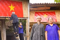Cụ ông và cụ bà bắc thang, cùng nhau vẽ cờ Tổ quốc
